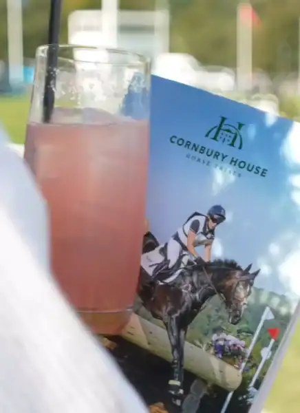 Refreshing pink drink with Cornbury House event brochure in background.
